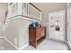 Inviting foyer featuring a staircase, a console table with decor, and a glimpse into the bright, modern kitchen at 11266 Old Stone Dr, Indianapolis, IN 46236