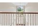 Hallway with white railing overlooking foyer with view out of front door at 11266 Old Stone Dr, Indianapolis, IN 46236