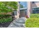 Inviting front entrance with a dark wood door, decorative planters, and lush greenery at 11266 Old Stone Dr, Indianapolis, IN 46236