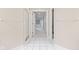 Bright hallway with tile flooring, multiple doorways, and neutral wall color at 11266 Old Stone Dr, Indianapolis, IN 46236