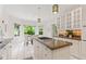 Spacious kitchen with white cabinetry, a granite island cooktop, and a breakfast nook overlooking the backyard at 11266 Old Stone Dr, Indianapolis, IN 46236
