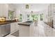 Bright kitchen featuring white cabinets, granite countertops, an island cooktop, and an adjacent breakfast nook at 11266 Old Stone Dr, Indianapolis, IN 46236