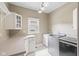 Well-equipped laundry room with ample counter space, cabinetry, a sink, and modern washer and dryer at 11266 Old Stone Dr, Indianapolis, IN 46236