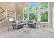 Spacious living room with a two-story window providing natural light and a cozy seating area at 11266 Old Stone Dr, Indianapolis, IN 46236