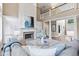 Open living room with a fireplace, a view of the staircase, and modern decor at 11266 Old Stone Dr, Indianapolis, IN 46236