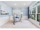 Bright home office with large windows, white trim, and comfortable seating at 11266 Old Stone Dr, Indianapolis, IN 46236