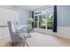 Cozy home office featuring a glass desk, comfortable chair, and natural light at 11266 Old Stone Dr, Indianapolis, IN 46236