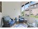 Screened patio featuring stylish wicker furniture, decorative pillows, and a view of the surrounding neighborhood at 11266 Old Stone Dr, Indianapolis, IN 46236