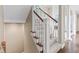 Carpeted staircase with white railings leads to the upper level with wood floors visible in the background at 11266 Old Stone Dr, Indianapolis, IN 46236