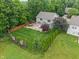 Aerial view of a home with a lush backyard featuring a stone patio, pergola, and mature trees at 11763 Igneous Dr, Fishers, IN 46038