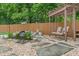 Backyard with a charming swing, small waterfall, lush greenery, and decorative stone work at 11763 Igneous Dr, Fishers, IN 46038