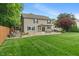 Large backyard showcasing a well-manicured lawn, stone patio with pergola, and privacy fence at 11763 Igneous Dr, Fishers, IN 46038