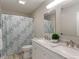 Charming bathroom featuring a double vanity, decorative shower curtain, and wood look flooring at 11763 Igneous Dr, Fishers, IN 46038