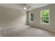 Neutral bedroom with bright windows and ceiling fan with wall to wall neutral carpeting at 11763 Igneous Dr, Fishers, IN 46038