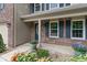 Close-up of the front entrance featuring brickwork, blue shutters, and decorative flowerpots at 11763 Igneous Dr, Fishers, IN 46038