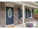 Charming brick home with a blue front door, black shutters, and a cozy covered porch with flower pot at 11763 Igneous Dr, Fishers, IN 46038