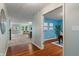 Inviting hallway leading to a living room and office featuring hardwood floors at 11763 Igneous Dr, Fishers, IN 46038