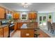 Beautiful kitchen features wood cabinets, stainless steel appliances, granite counters, and backyard views at 11763 Igneous Dr, Fishers, IN 46038