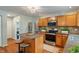 Well-lit kitchen features wood cabinets, stainless steel appliances, granite counters, and eat-in breakfast bar at 11763 Igneous Dr, Fishers, IN 46038