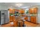 Beautiful kitchen features wood cabinets, stainless steel appliances, granite counters, and recessed lighting at 11763 Igneous Dr, Fishers, IN 46038