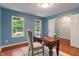 Bright home office with hardwood floors, blue walls, and ample natural light from two windows at 11763 Igneous Dr, Fishers, IN 46038