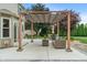 Beautiful patio with pergola, cozy outdoor furniture, and lush landscaping, perfect for relaxation at 11763 Igneous Dr, Fishers, IN 46038
