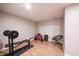Finished basement space with weightlifting bench, chair and pegboard on the wall at 13829 Black Canyon Ct, Fishers, IN 46038