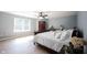 A primary bedroom features wood floors, a ceiling fan, and bright windows at 13829 Black Canyon Ct, Fishers, IN 46038