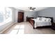 A bright primary bedroom has a wooden bed frame and wardrobe with light wood floors at 13829 Black Canyon Ct, Fishers, IN 46038