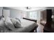 Bright bedroom features a ceiling fan, light blue walls, and a bright window at 13829 Black Canyon Ct, Fishers, IN 46038