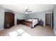 Light-filled bedroom features a wooden sleigh bed, ceiling fan, and wood floors at 13829 Black Canyon Ct, Fishers, IN 46038