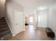 Inviting foyer with hardwood floors, staircase, and access to the living area, showcasing a welcoming entrance at 13829 Black Canyon Ct, Fishers, IN 46038