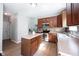 Efficient kitchen featuring wood cabinets, stainless steel appliances, island, and open to eating area at 13829 Black Canyon Ct, Fishers, IN 46038