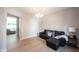 Inviting living room showcasing a black leather sectional sofa and a window providing natural light at 13829 Black Canyon Ct, Fishers, IN 46038