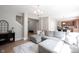 Open-concept living room featuring a comfortable gray sectional sofa and view to the kitchen at 13829 Black Canyon Ct, Fishers, IN 46038