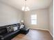 Inviting living room showcasing a black leather sectional sofa and a window providing natural light at 13829 Black Canyon Ct, Fishers, IN 46038