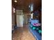 Compact bedroom with wooden walls and ceiling, including a wardrobe and neatly organized caps at 1425 Sharon Ave, Indianapolis, IN 46222