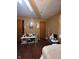 The bedroom includes a large table and a dark wooden floor with a window for natural light at 1425 Sharon Ave, Indianapolis, IN 46222