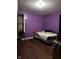 This bedroom has hard wood floors and a TV with light coming in from the window at 1425 Sharon Ave, Indianapolis, IN 46222