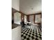 An eat-in kitchen showcasing checkerboard flooring with a dining table and classic white trim at 1425 Sharon Ave, Indianapolis, IN 46222