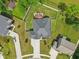 An aerial view of a home with a deck and patio, surrounded by a white fence and green lawn at 14729 Erica Ln, Carmel, IN 46033