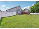 Well-maintained backyard with a large lawn, a wooden deck, and a white privacy fence at 14729 Erica Ln, Carmel, IN 46033