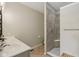 Bathroom features a double vanity, tile floor, and a tiled shower stall with a built-in seat at 14729 Erica Ln, Carmel, IN 46033