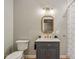 Bathroom featuring a stylish vanity with gray cabinet and marble countertop, complemented by modern fixtures and neutral tones at 14729 Erica Ln, Carmel, IN 46033
