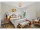 Charming bedroom featuring a rattan bed frame, woven wall decor, and plenty of natural light at 14729 Erica Ln, Carmel, IN 46033