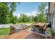 Spacious wooden deck with outdoor dining set and seating area overlooking expansive backyard and green lawn at 14729 Erica Ln, Carmel, IN 46033