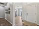 Bright foyer with wood floors, a white front door, transom window, and a view into an office/sitting room at 14729 Erica Ln, Carmel, IN 46033