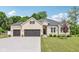 Charming, light brick home with a well-manicured lawn and an attached two-car garage at 14729 Erica Ln, Carmel, IN 46033