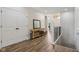 Inviting entryway with a console table, mirror, and hardwood floors leading to an open staircase at 14729 Erica Ln, Carmel, IN 46033