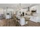 Modern kitchen with a large granite island, stainless steel appliances, and wood-style flooring for a sleek design at 14729 Erica Ln, Carmel, IN 46033